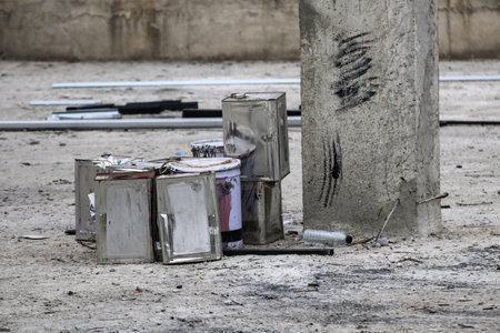 Empty paint buckets and thinner buckets Place the pile next to the cement column. in the...