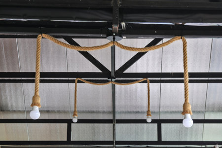Installation of beautiful lamps in a coffee shop by using ropes as a component to decorate the shop.の写真素材