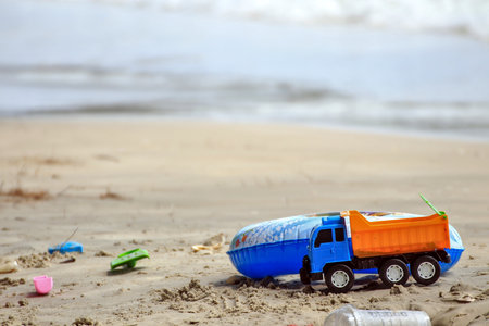 Toy trucks, colorful floats and sand toys on a beach in Thailandの写真素材