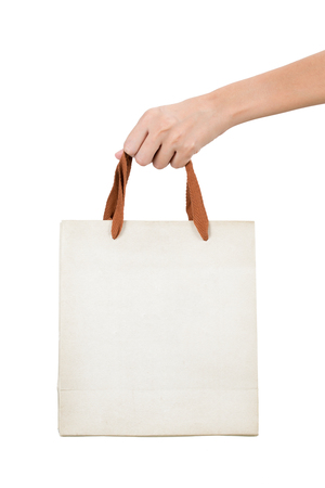 Woman hand holding brow paper bag, isolated on white background.の写真素材