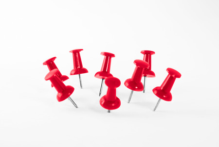 Red push pins group , on white background.