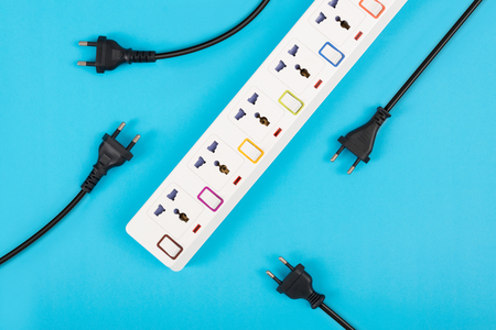 Electrical power strip or extension block and empty outlet tap with switch, grounded top view on colorful background and copy space, electric equipment flat lay concept.の写真素材