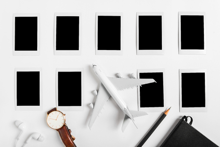 Preparation for Traveling concept, watch, airplane, pencils, book, earphone, Photo frame, on white background with copy space.の写真素材
