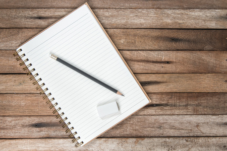 Creative vintage Table with empty page and pencil, rubber eraser Top View with Copy Space, on vintage background.の写真素材