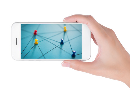 Woman using smart phone searching small network of colorful push pins linked together by string on blue background. Network and connections concept, isolated on white background.の写真素材