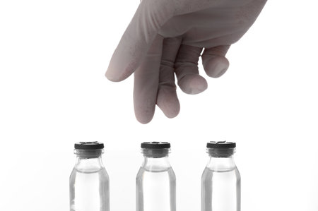 Doctor or scientist hands wear rubber gloves taking medicine vials in the laboratory- Health Beauty and medical concepts- Isolated on white backgroundの写真素材