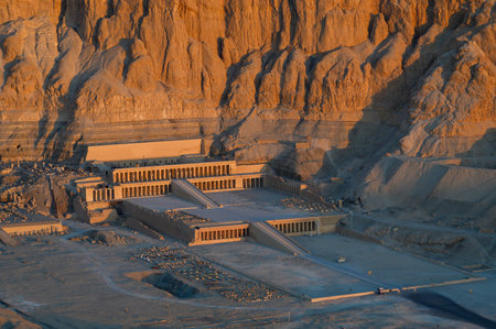 Aerial view of Hatshepsut Temple at sunrise in Valley of the Kings and red cliffs western bank of Nile river- Luxor- Egyptの写真素材