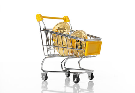 Full of gold bitcoins cryptocurrency in shopping cart- virtual cryptocurrency concept- isolated on white backgroundの写真素材