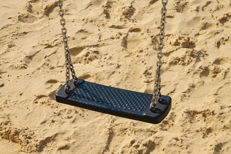 Photo of empty swing on children playground. Close-up.