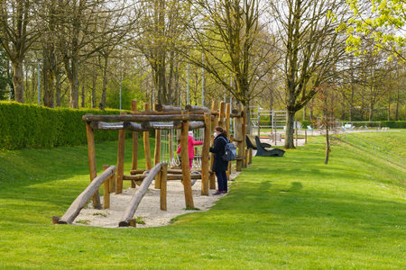PADERBORN, GERMANY. PARK 05/04/2021 Mom with a child on the playground during a pandemic.のeditorial素材
