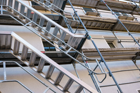 Frame of metal scaffolding with ladders on a building under construction.の写真素材
