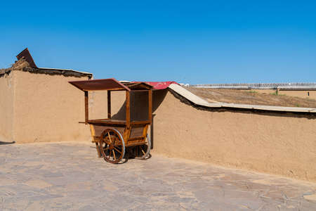Wooden cart of a street vendor on the background of a clay wall. Central Asia.の写真素材