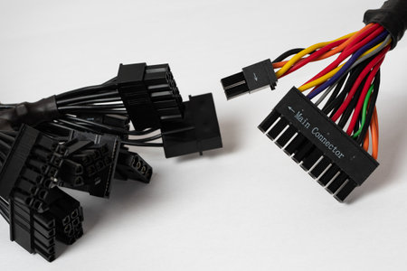 Black cable with adapter for connecting to the computer motherboard on a white background. Close up.