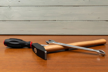 Hammer, screwdriver and wrench lie on the table. Close up.の写真素材