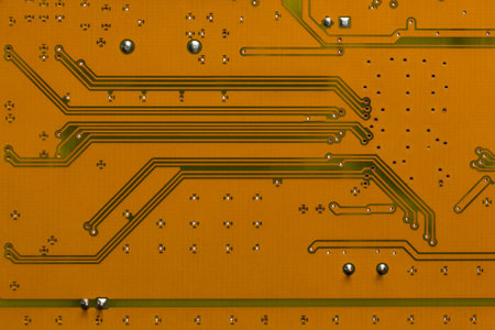 The reverse side of the electronic circuit board is yellow-brown. close up