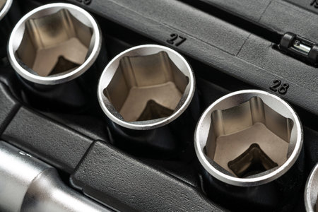 Cap sockets for loosening nuts lying in a row in a box for hand tools. close up