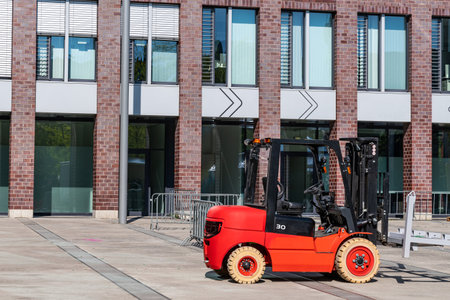 Forklift at a construction site against the backdrop of a large building. Side view.の写真素材