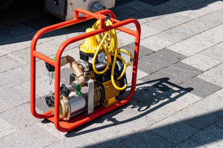 Fire portable pump for supplying pressure in a hose with water. Close-up.の写真素材
