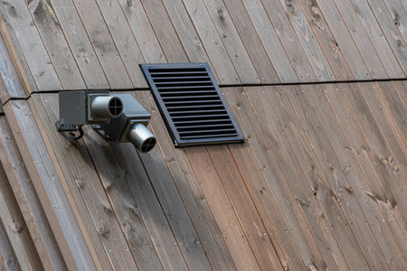 Lighting fixtures and ventilation grille on a wooden roof. Close up.