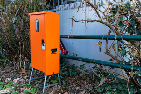Orange electrical switch cabinet with padlock.の写真素材