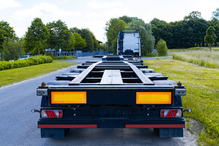 Rear view of an empty semi-trailer standing on the side of the road.の写真素材