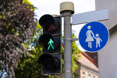 Street pedestrian traffic light for crossing the road with a burning green color. Close up.の写真素材