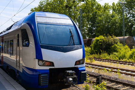 Front view of a passenger electric train standing on the platform..