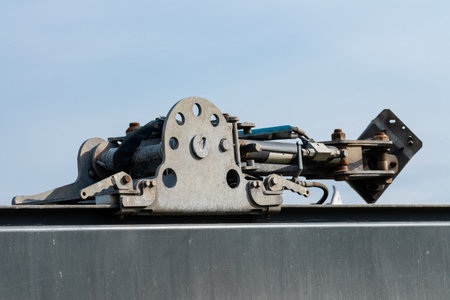 A mechanical component is mounted on a metallic surface under clear skies. The part features...