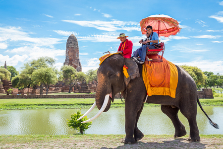 AYUTTHAYA, THAILAND - August 22, 2015: Tourists on an elephant ride tour of the ancient city on August 22, 2015 in Ayutthaya.のeditorial素材
