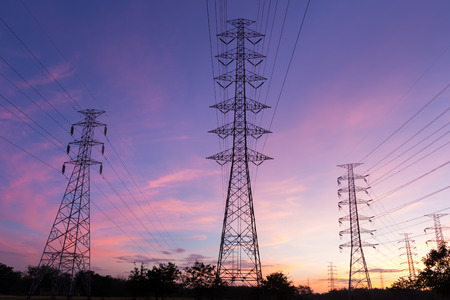 Silhouette high voltage electricity pylon on sunrise backgroundの写真素材