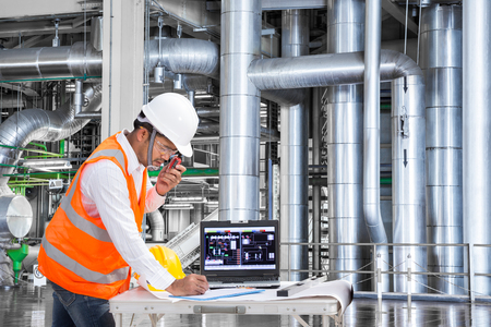 Engineer using laptop computer for maintenance equipment in thermal power plant factoryの写真素材