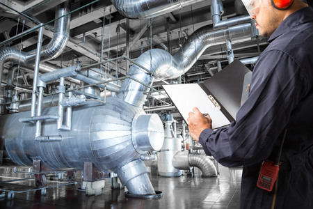 Engineer taking notes at thermal power plant factoryの写真素材