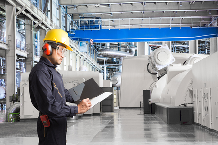 Engineer taking notes for maintenance work  in thermal power plant factoryの写真素材