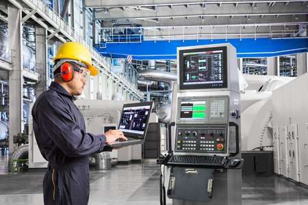 Engineer using laptop computer for maintenance equipment in thermal power plant factoryの写真素材