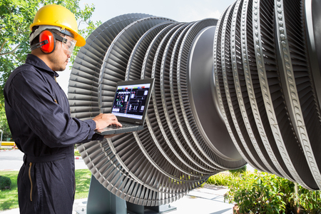Engineer using laptop computer for maintenance steam turbine of thermal power plantの写真素材
