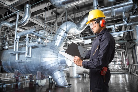 Engineer taking notes at thermal power plant factoryの写真素材