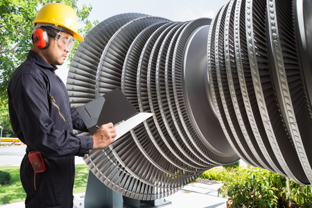 Engineer taking notes for maintenance steam turbine of thermal power plantの写真素材