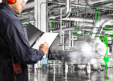 Engineer taking notes at thermal power plant factoryの写真素材