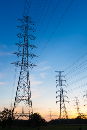 Silhouette high voltage electricity pylon on sunrise backgroundの写真素材