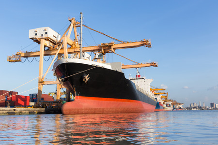 Cargo ship in the harbor for logistic import export backgroundの写真素材