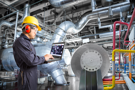 Engineer using laptop computer for maintenance in thermal power plant industrailの写真素材