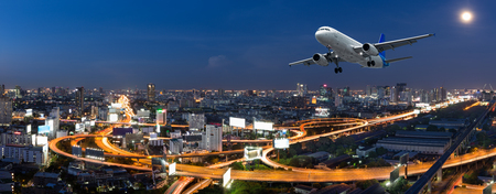 Airplane take off over the panorama city at twilight sceneのeditorial素材