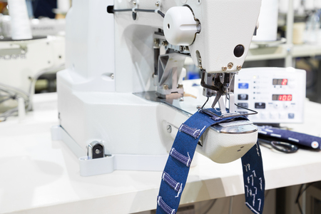 Sewing machine process a seam on jeans fabricの写真素材