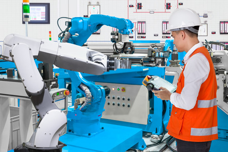 Maintenance engineer programing automated robotic industry 4.0 conceptの写真素材