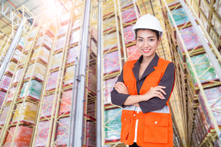 Business woman smiling in warehouseの写真素材