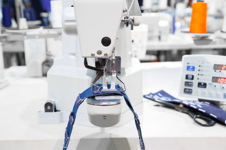 Sewing machine process a seam on jeans fabricの写真素材