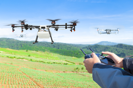 Farmer control agriculture drone fly to sprayed fertilizer on the lettuce fieldの写真素材