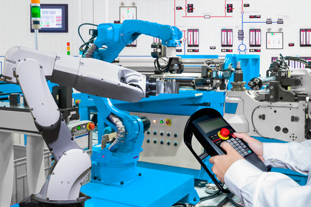 Engineer control automatic robotic hand machine tool at industrial manufactureの写真素材