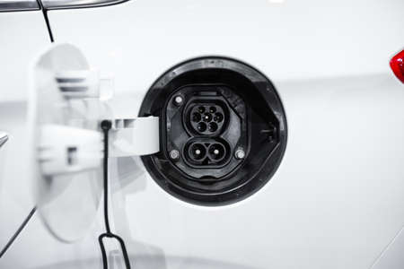 Close-up female electric power plug of white electric carの写真素材