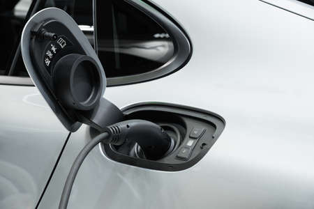 Electric car charging with power plug, Technology electric vehicle conceptの写真素材
